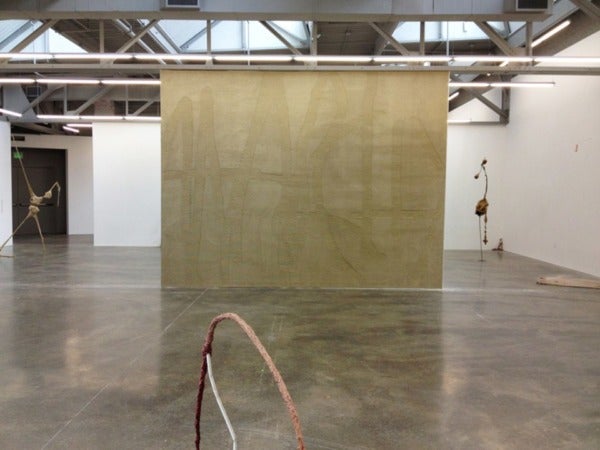 industrial exhibition space, sparsely occupied by artworks