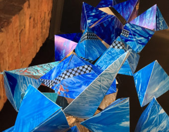 Artwork by Stacie Rose. A jumble of angular blue forms.