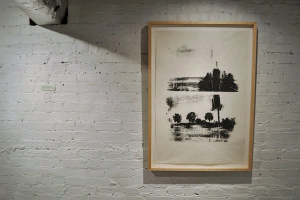 A framed silkscreen print showing two black-and-white images of billboards and palm trees.