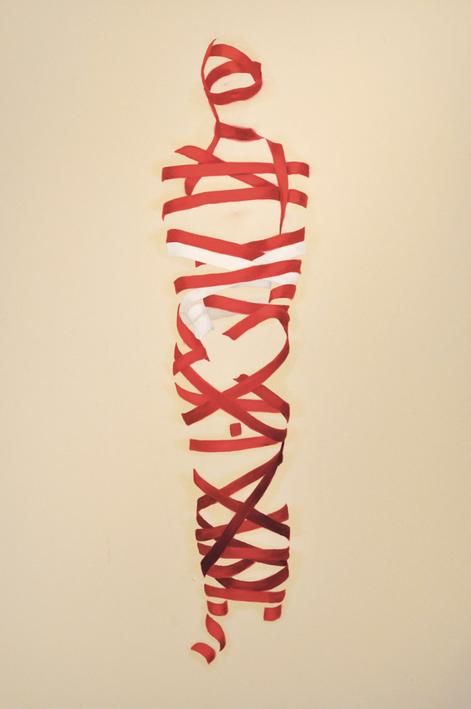 red and white ribbon wrapped around the silhouette of female figure