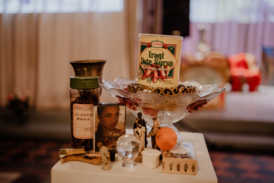 installation image of sculptures include a sade album and can of iraqui dates