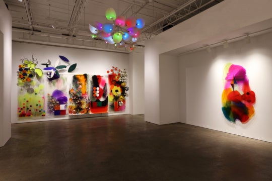 installation view of sculptures on gallery walls